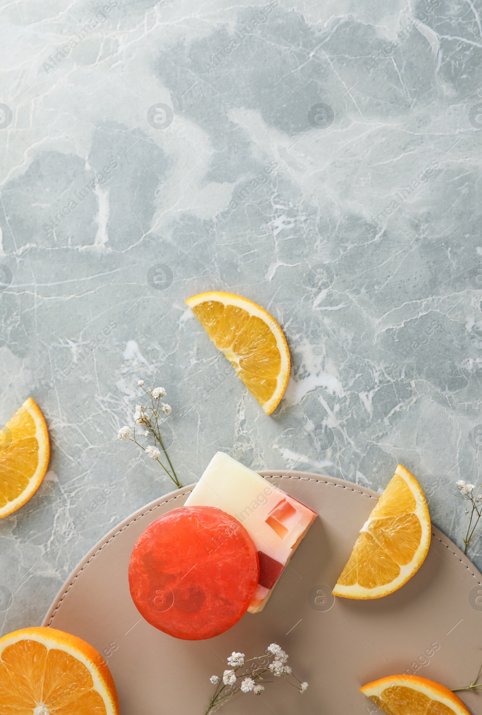 Photo of Flat lay composition with soap and orange slices on light grey marble background. Space for text