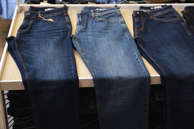Photo of Stylish blue jeans on display in shop