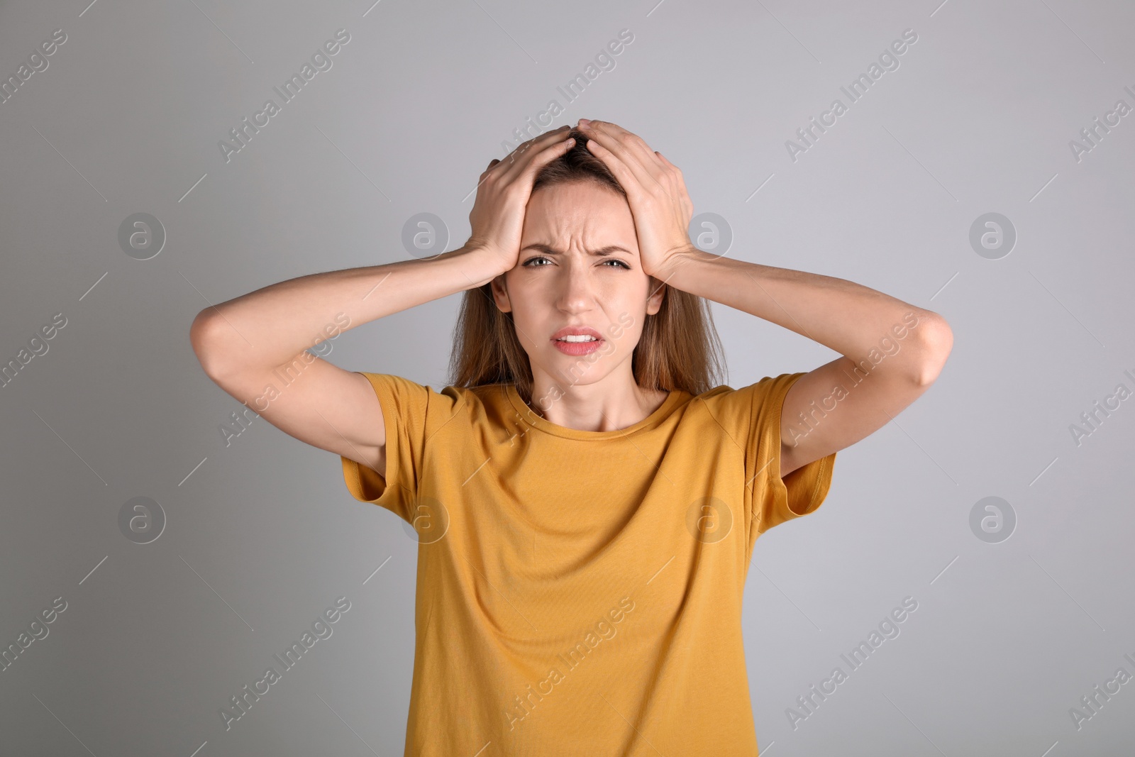 Photo of Portrait of stressed young woman on grey background