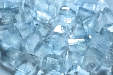 Pile of ice cubes on color background