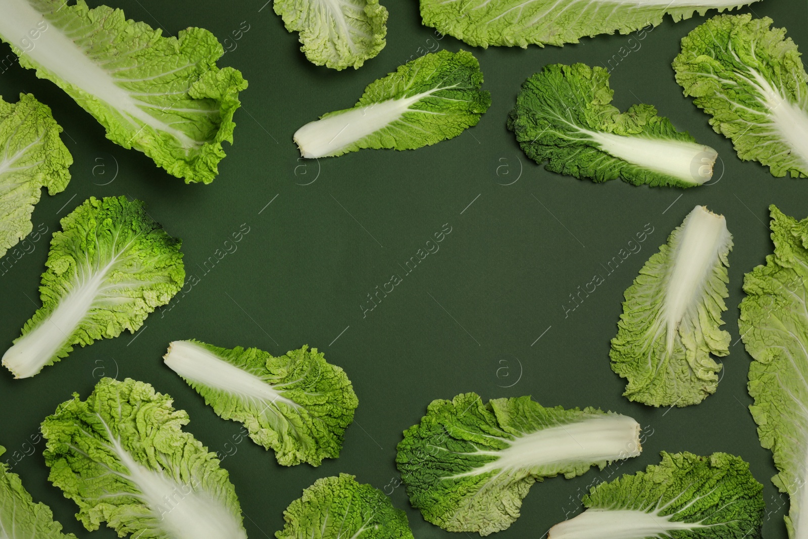 Photo of Frame with fresh ripe leaves of Chinese cabbage on green background, flat lay. Space for text
