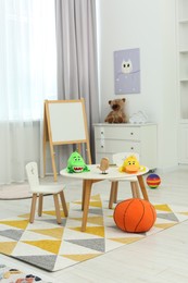 Photo of Child`s playroom with different toys and modern furniture. Stylish kindergarten interior