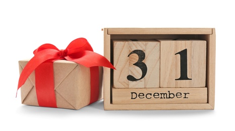 Wooden block calendar and gift box on white background. Christmas countdown