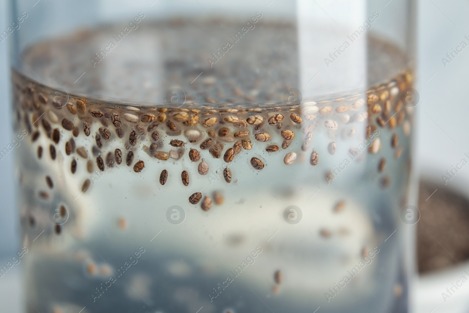 Photo of Glass of water with chia seeds, closeup