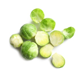 Photo of Fresh Brussels sprouts and leaves on white background, top view