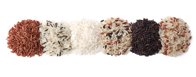 Photo of Different types of brown and polished rice isolated on white, top view