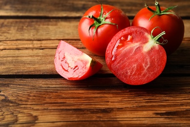 Fresh ripe red tomatoes on wooden table