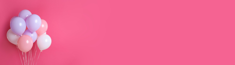 Image of Bunch of color balloons on pink background, space for text. Banner design 