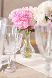 Stylish table setting with beautiful peonies indoors