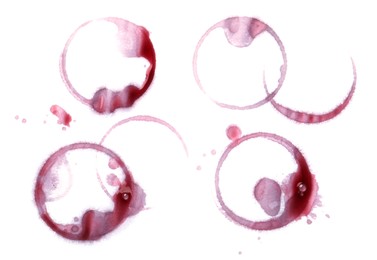 Photo of Red wine rings and drops on white background, top view