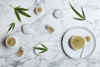 Photo of Flat lay composition with hemp lotion on marble background