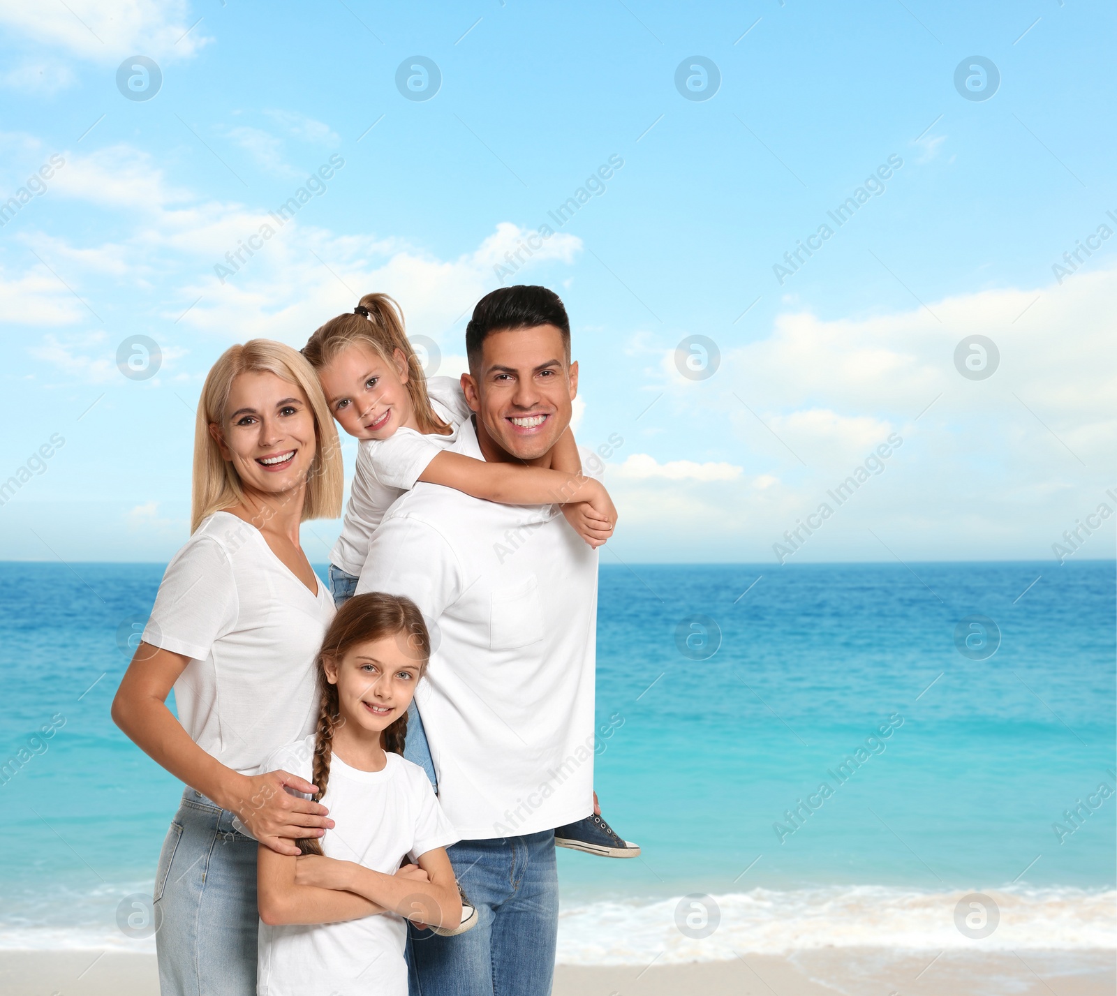 Image of Happy family on sandy beach near sea. Summer vacation