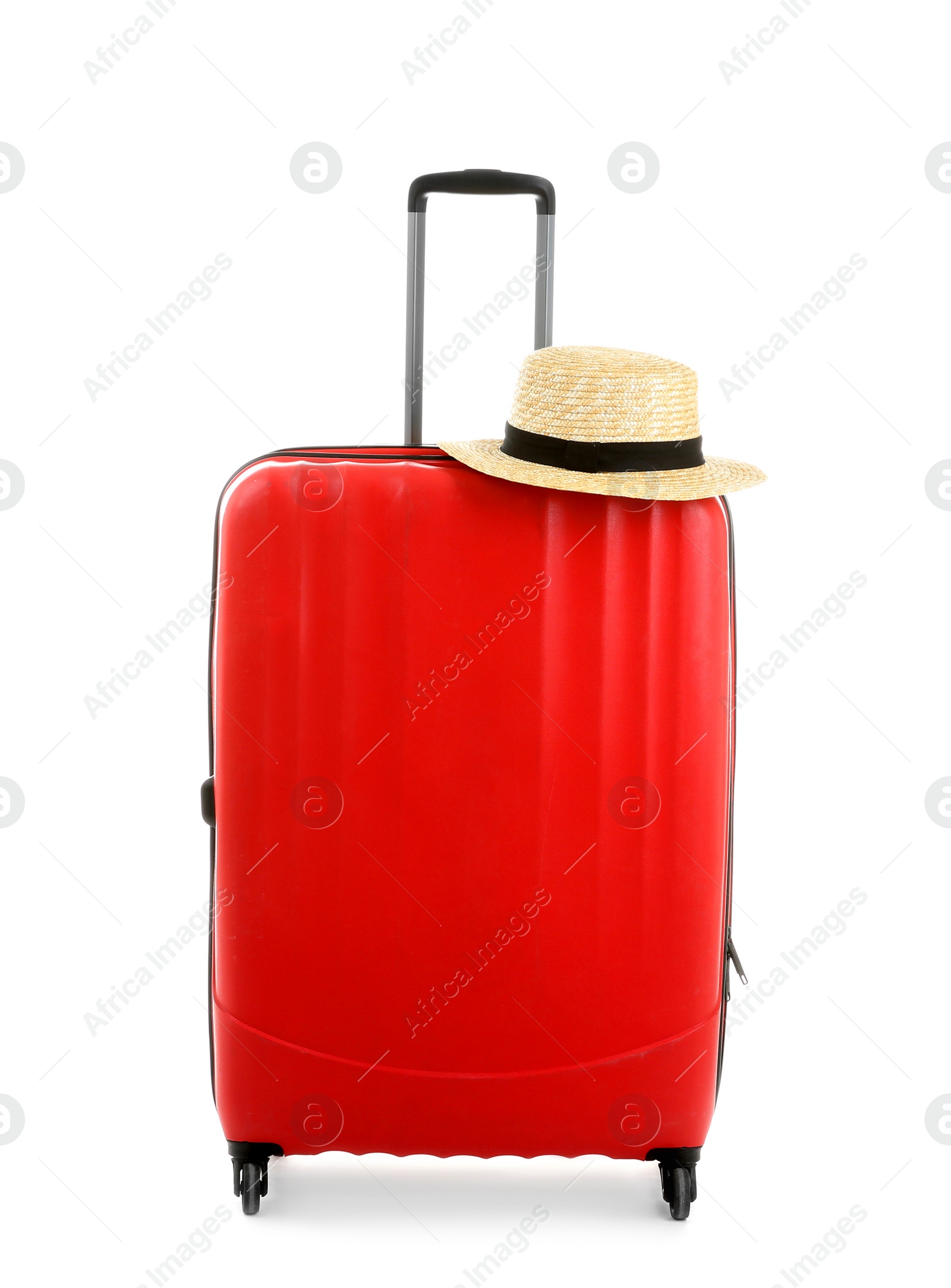 Photo of Packed suitcase with hat on white background