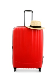 Photo of Packed suitcase with hat on white background