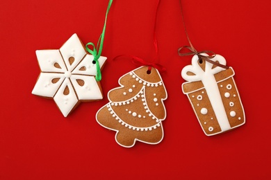 Different delicious Christmas cookies on red background, flat lay