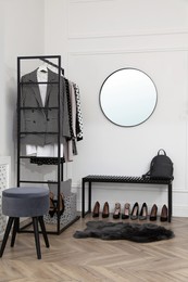 Dressing room with stylish clothes, shoes and accessories. Elegant interior design