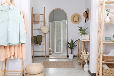 Hallway interior with stylish furniture and floor mirror