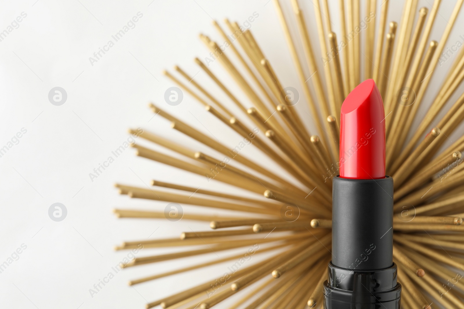 Photo of Beautiful lipstick and golden decoration on white background, top view. Space for text