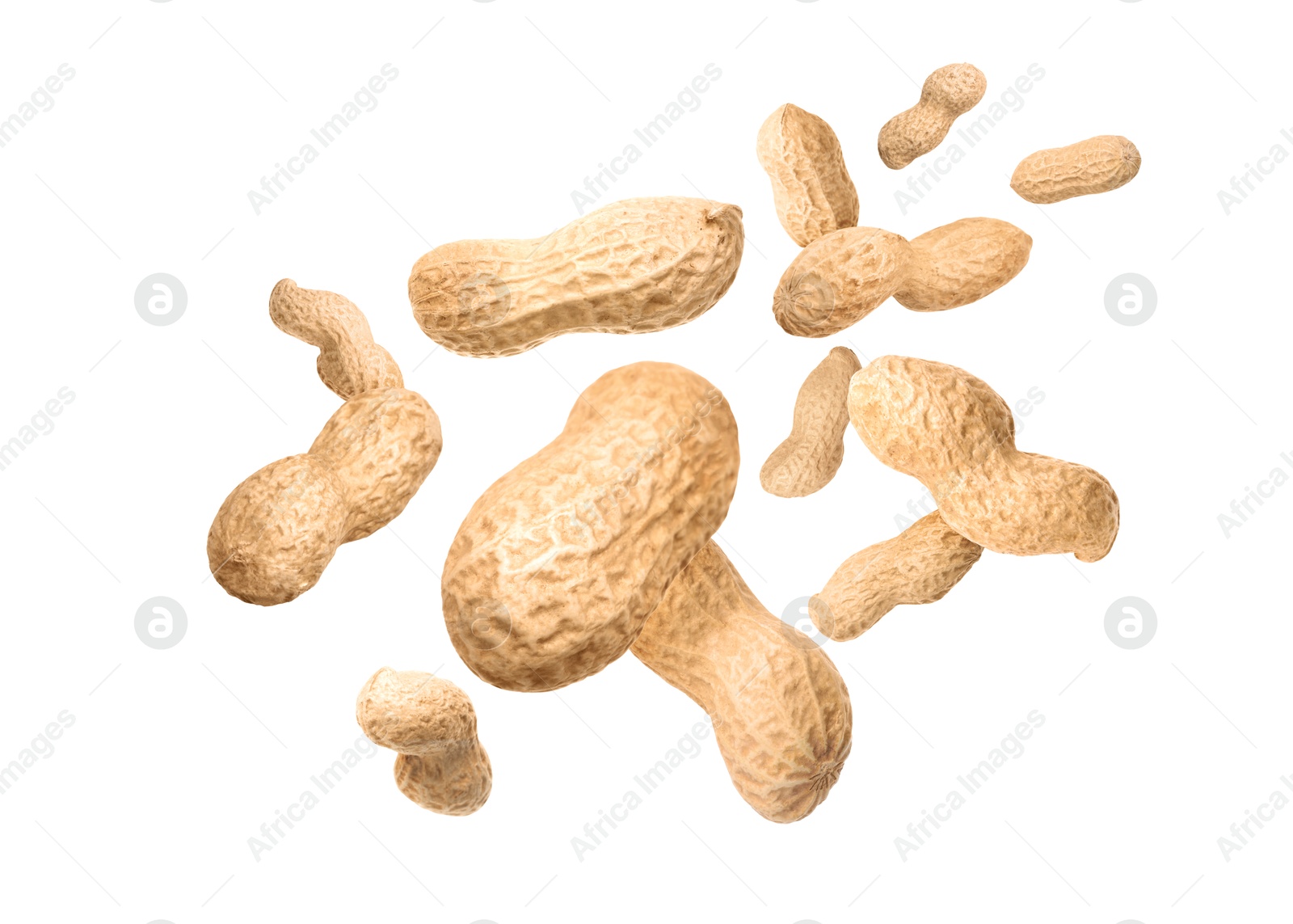 Image of Unpeeled peanuts in air on white background