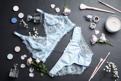 Photo of Flat lay composition with elegant women's underwear on black stone background
