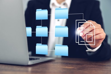 File system. Woman with laptop at table, closeup. User organizing folders and documents on virtual screen