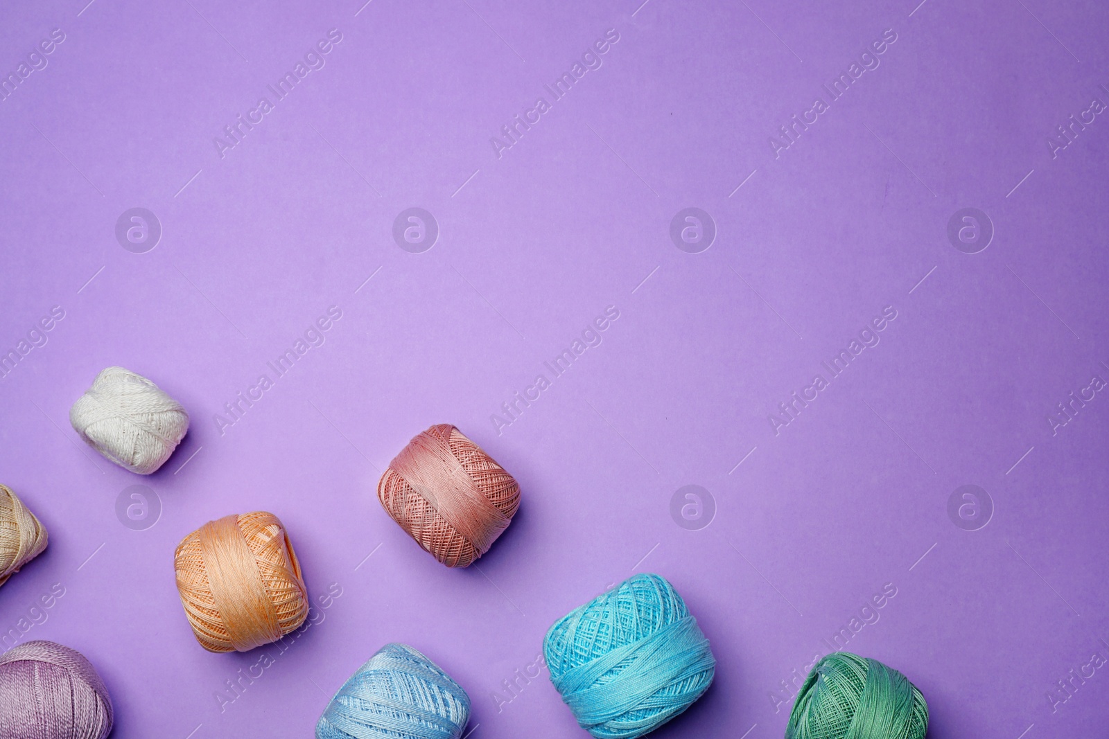 Photo of Flat lay composition with sewing threads on color background