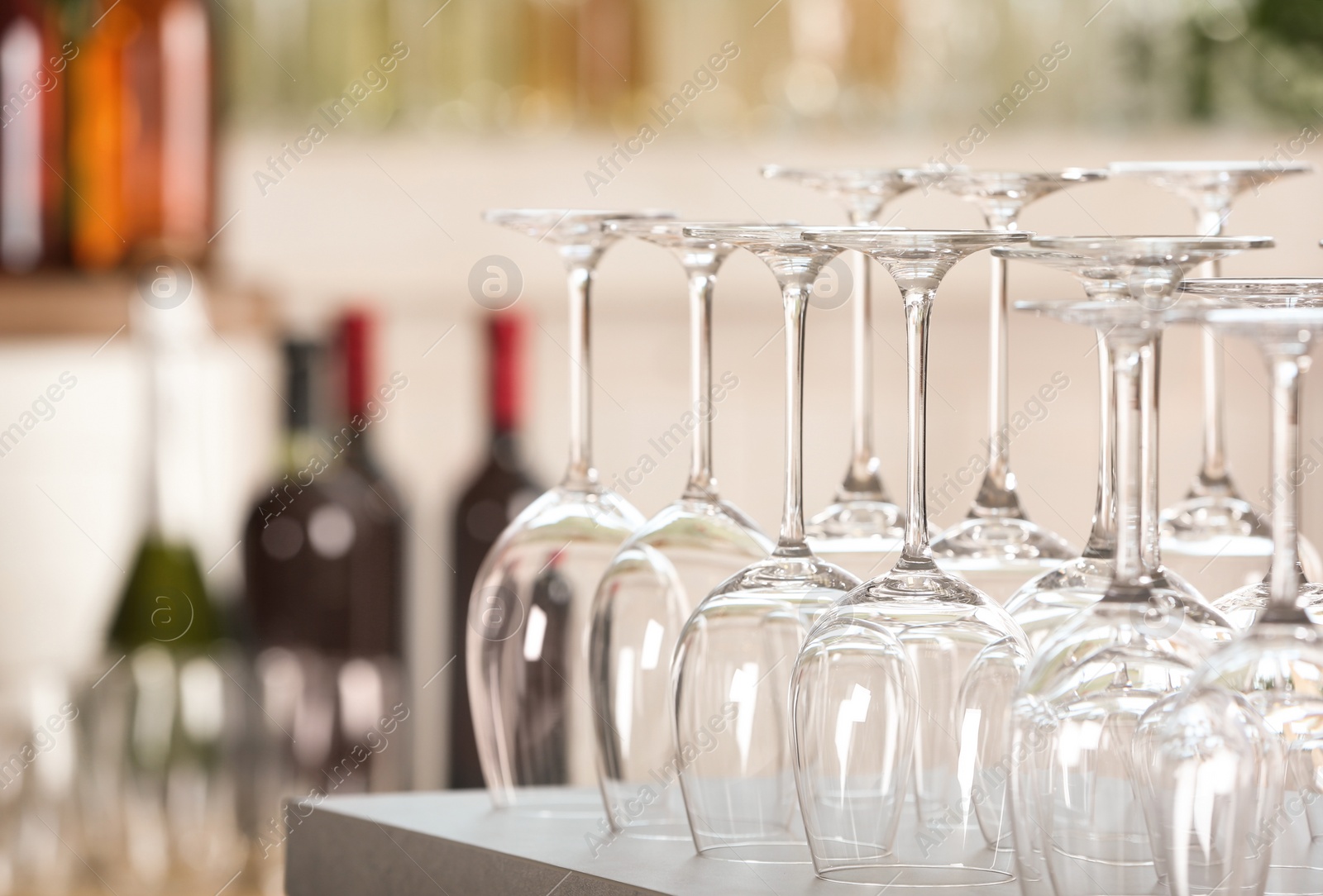 Photo of Empty glasses on table against blurred background