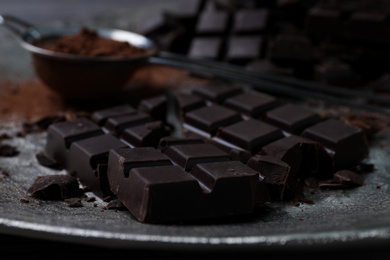 Delicious dark chocolate on metal plate, closeup
