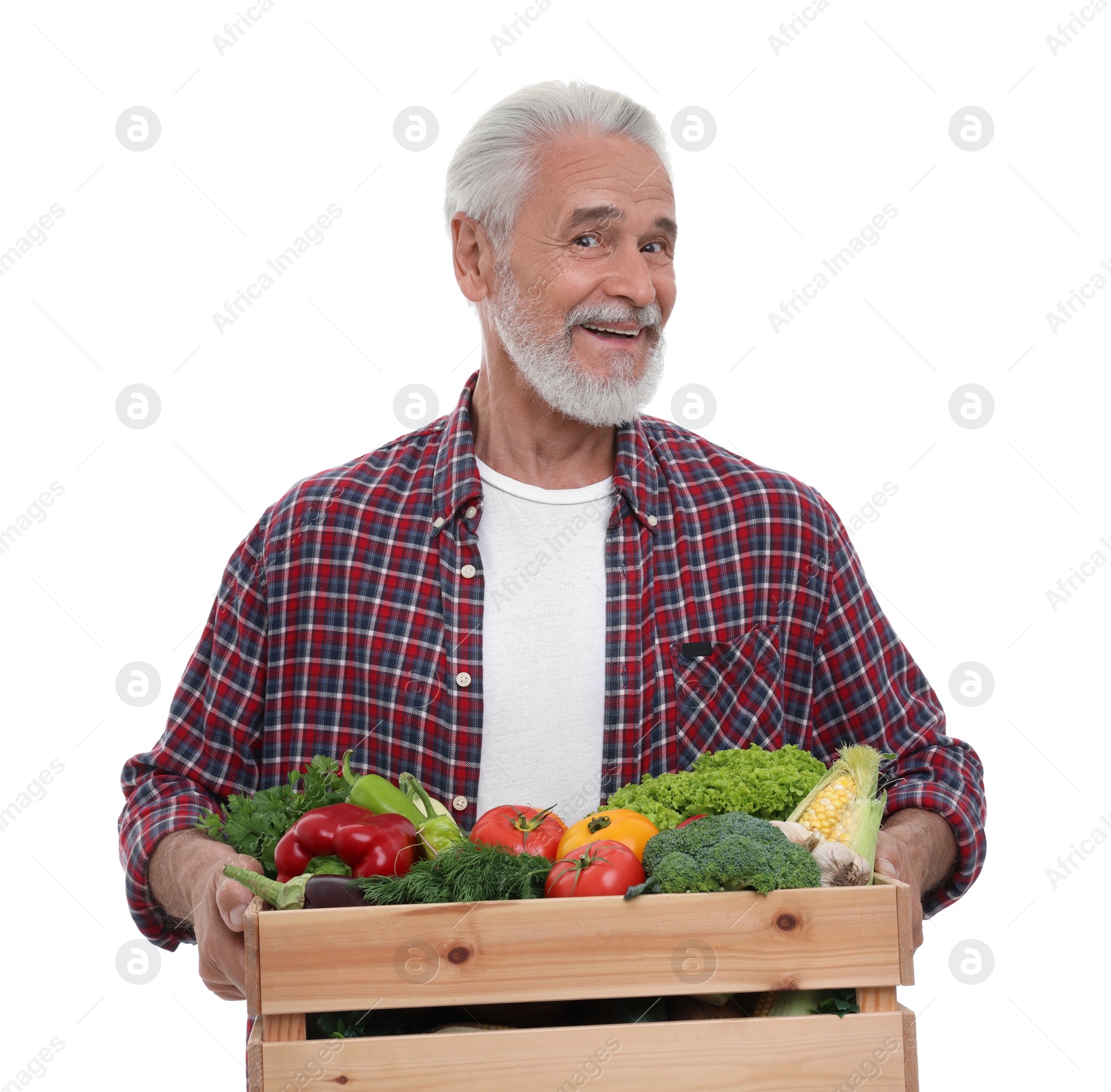 Photo of Harvesting season. Happy farmer holding wooden crate with vegetables on white background