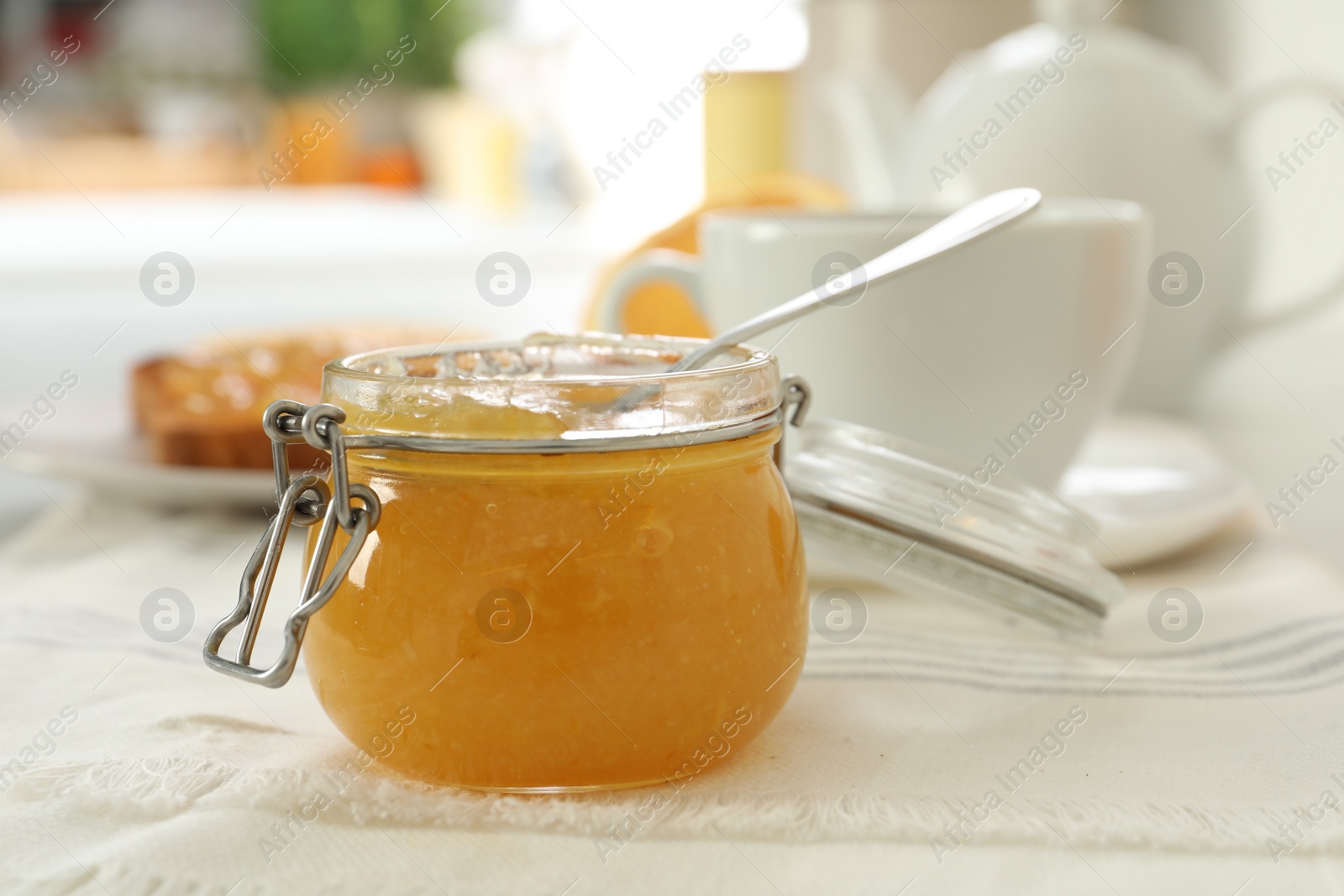 Photo of Delicious orange marmalade on table. Space for text