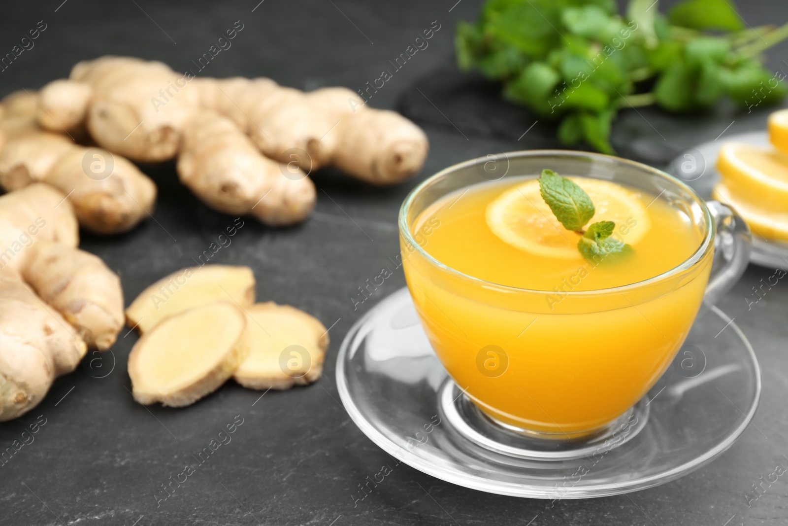 Photo of Immunity boosting drink and ingredients on dark table