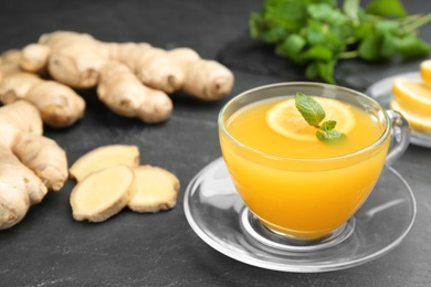 Photo of Immunity boosting drink and ingredients on dark table