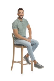 Photo of Handsome man sitting on stool against white background