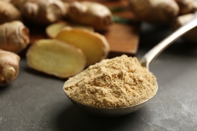 Photo of Dry and fresh ginger on grey table, closeup