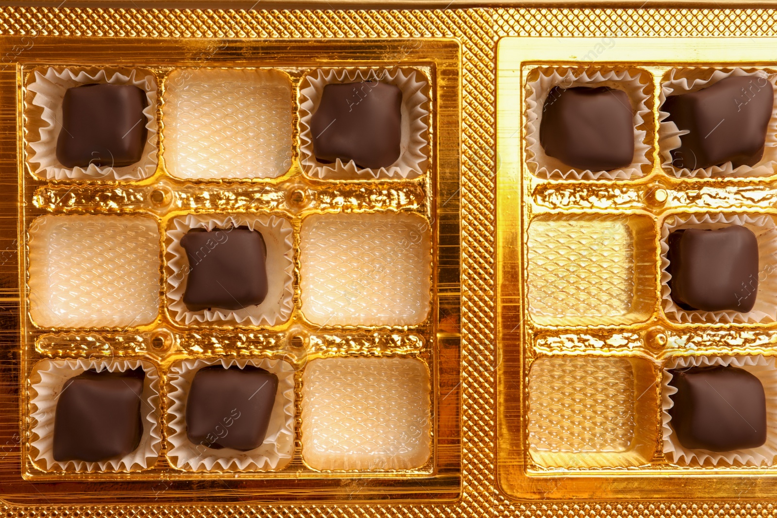 Photo of Partially empty box of chocolate candies as background, top view