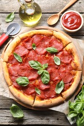 Flat lay composition with tasty pepperoni pizza on wooden table