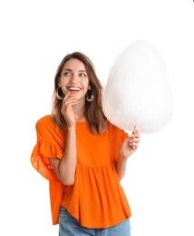 Photo of Happy young woman with cotton candy on white background