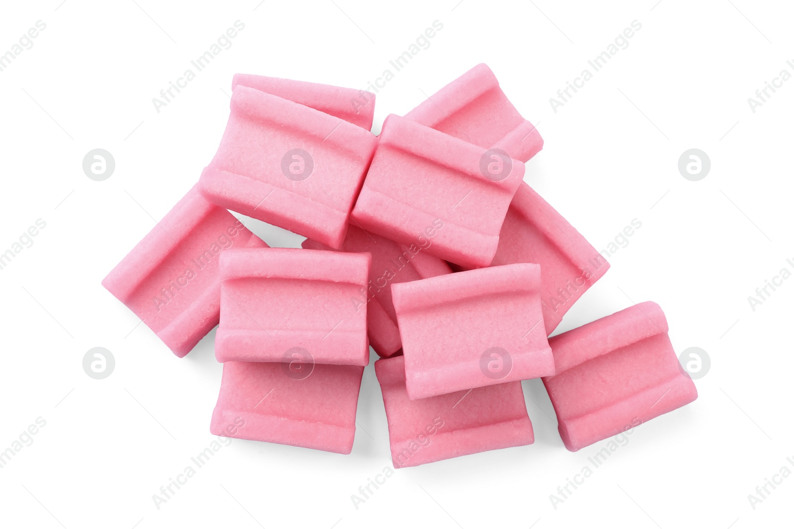 Photo of Pile of tasty pink chewing gums on white background, top view