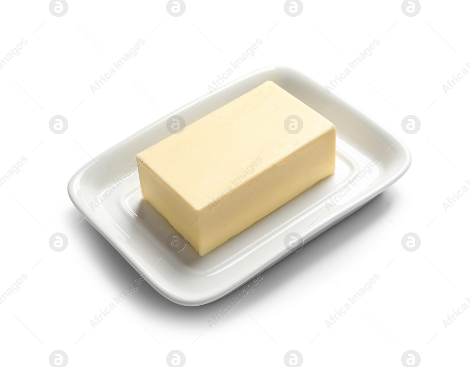 Photo of Ceramic dish with block of fresh butter on white background