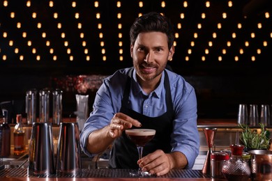 Bartender preparing Espresso Martini in bar. Alcohol cocktail