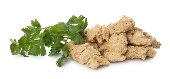 Dehydrated soy meat chunks with parsley on white background