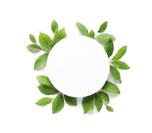 Photo of Blank card and spring green leaves on white background, top view. Space for text