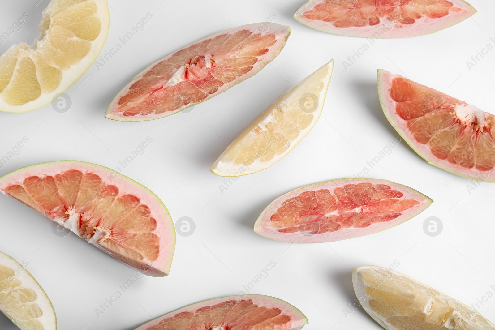 Photo of Slices of different ripe pomelos on white background, flat lay