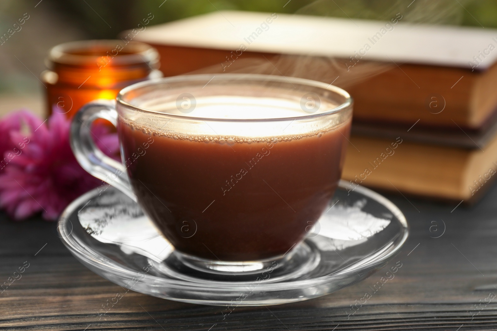 Photo of Glass cup with coffee on wooden table, closeup. Morning ritual