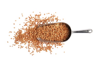 Photo of Scoop with uncooked buckwheat on white background, top view