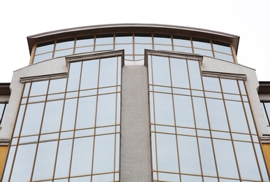 Photo of Modern office building with tinted windows against sky