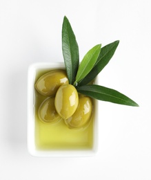 Photo of Bowl with fresh olives in oil on white background, top view