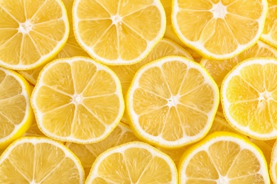 Photo of Slices of fresh lemon as background, top view