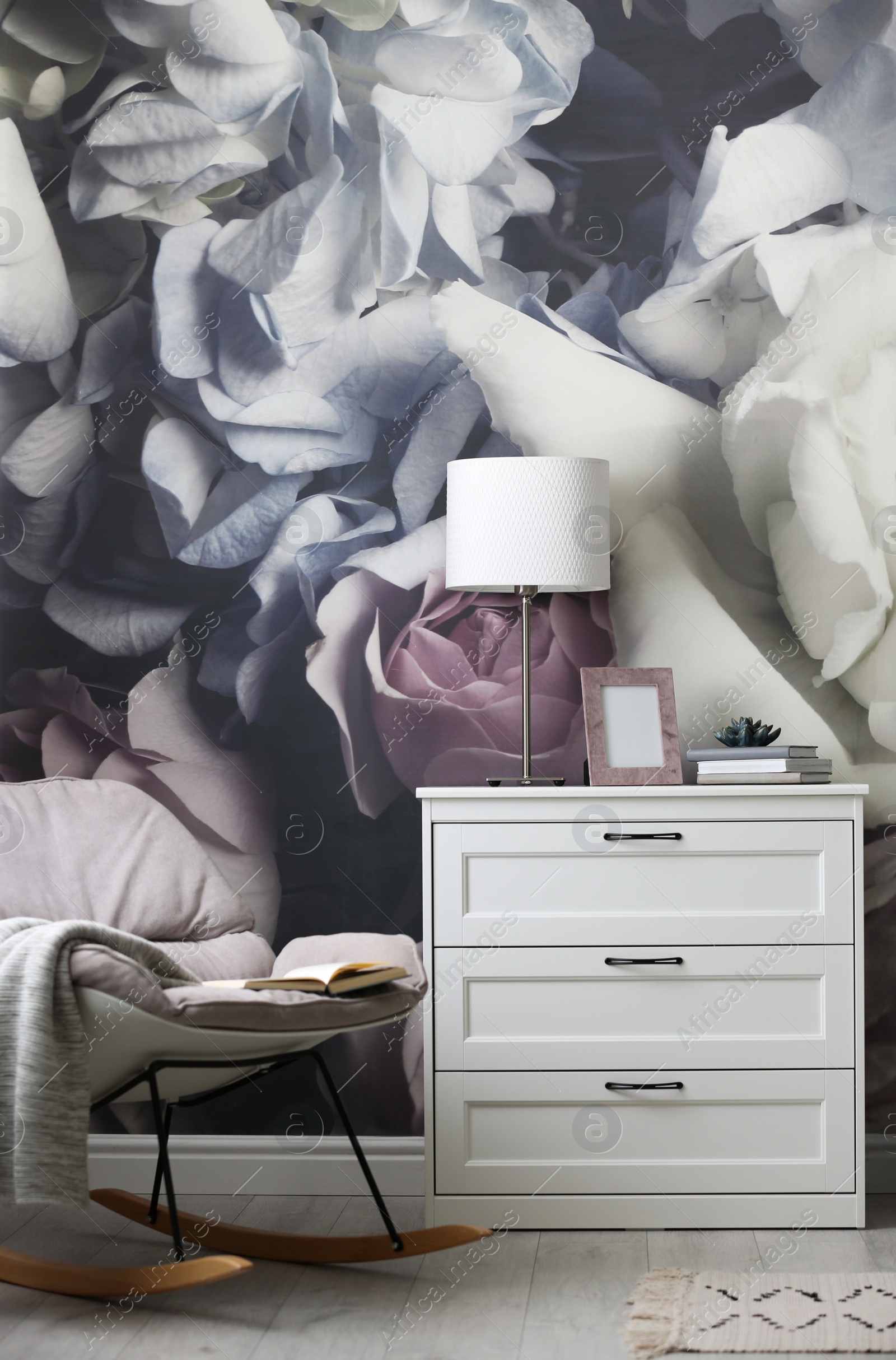 Photo of White chest of drawers in stylish living room. Interior design