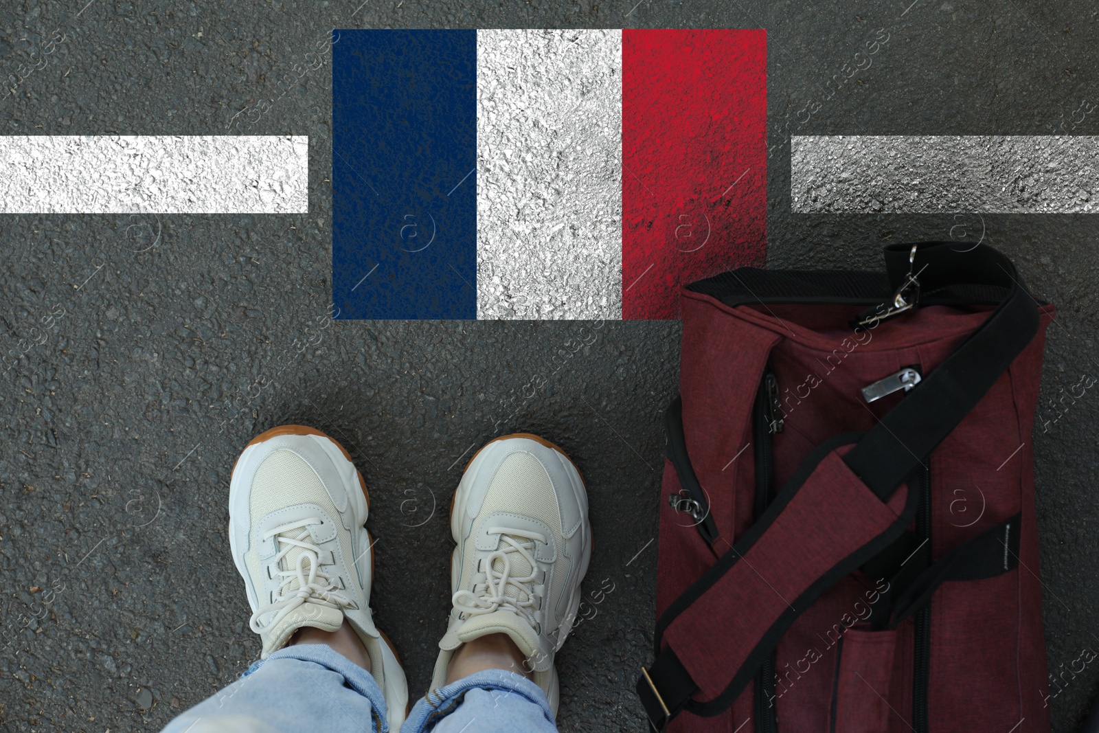 Image of Immigration. Woman with bag standing on asphalt near flag of France, top view